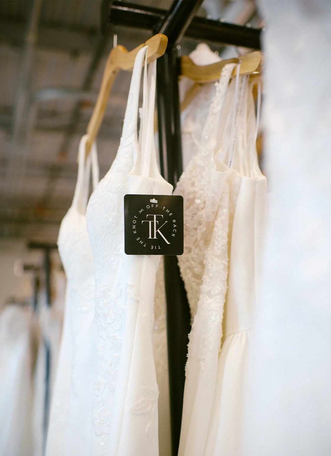 Photo of bridal gowns on the rack.