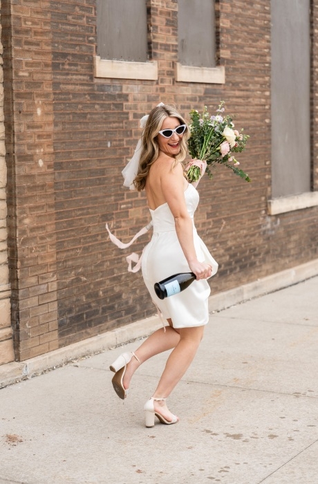 Photo of the smiling model wearing a white gown